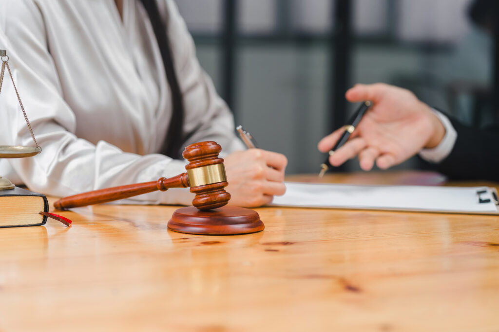 Lawyer advises client signing document, highlighting legal consultation and agreement process.