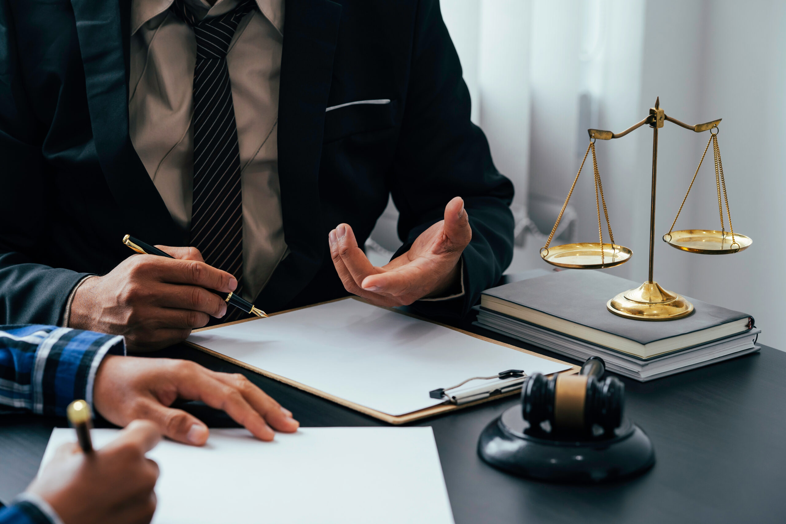 A lawyer or legal counsel is listening and providing advice to business people.