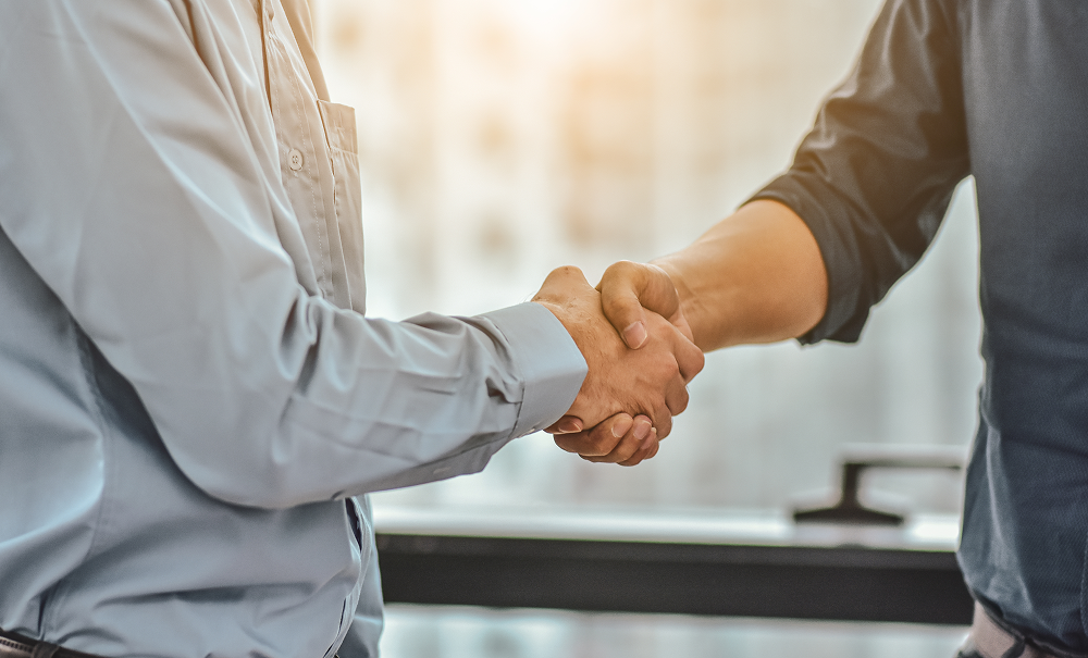 Lawyers shake hands with a client