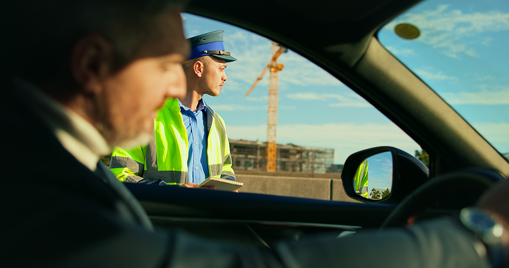 policeman giving a fine to a driver